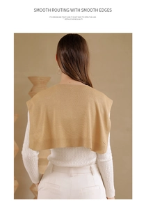 Detail of warm ginger knitted shawl showing smooth routing and premium ribbed edge quality