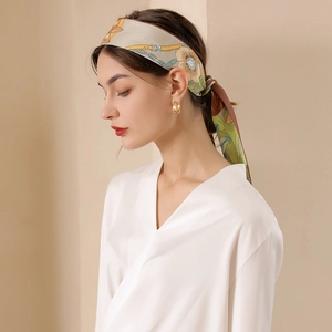 Elegant floral print silk ribbon scarf paired with golden hoop earrings for women