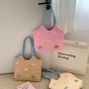 Three knit tote bags with colorful 3D bows in pink, khaki, and cream for summer fashion