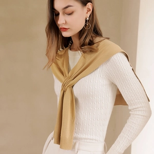 Women's cable knit sweater in cream white with a mustard yellow decorative knit shawl