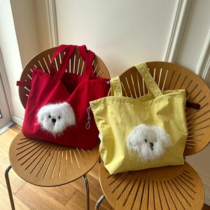 Close-up of canvas tote bag featuring 3D plush puppy decor and adjustable drawstrings
