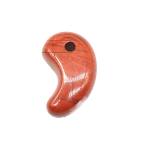Natural red jasper magatama pendant with polished surface on white background