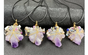 Detailed wire-wrapped raw amethyst pendants featuring pearls on black cord necklaces