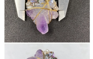 Macro detail of handmade wire-wrapped amethyst pendant with pearls and shell accents