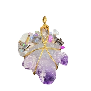 Handmade amethyst crystal pendant with wire wrap detail and colorful stones on white background