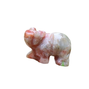 Polished natural semi-precious stone polar bear animal figurine in mottled orange and white