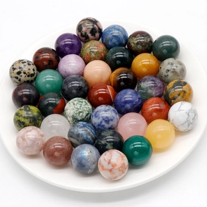 Polished 20mm natural stone spheres including amethyst and tiger eye in white bowl