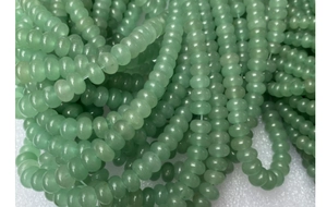 Macro shot of light green abacus-shaped aventurine beads for DIY jewelry making