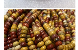 Macro shot of natural Mookaite Jasper abacus beads with rich red and yellow textures