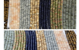 Detalle macro de varias cuentas de ojo de tigre y jaspe para joyería artesanal