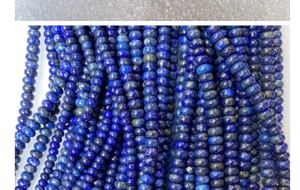 Macro view of blue natural lapis lazuli abacus beads with golden pyrite spots