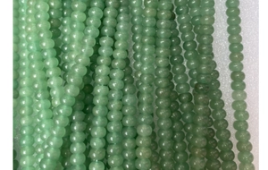 Detailed macro view of light green aventurine abacus spacer beads for jewelry DIY