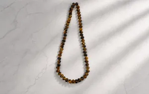 Detailed view of polished tiger eye abacus beads with natural chatoyancy textures