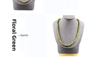 Detail view of woven natural stone necklace with green and orange mottled beads
