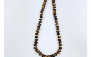 Detail of hand-woven natural tiger eye stone necklace with gradient brown wheel beads