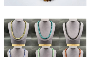 Detail showing natural stone bead necklaces in various colors on jewelry display stands