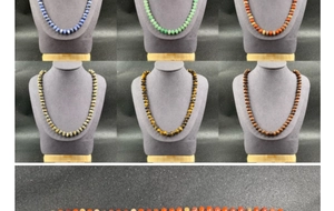 Detail of natural stone wheel-bead necklaces showcasing various colorful gemstone textures