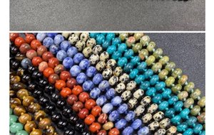 Close-up of assorted natural stone beads including tiger eye and red jasper necklaces