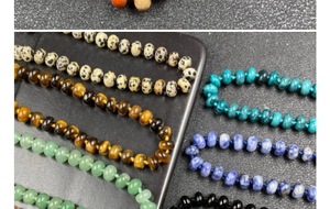 Detailed macro shot of natural stone abacus beads showing varied textures and earthy colors