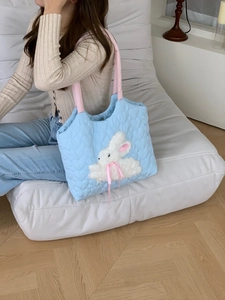 Light blue quilted shoulder bag featuring cute plush rabbit and pink ribbon detail