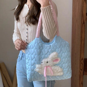 Quilted light blue tote bag with plush bunny embroidery and heart pattern stitching