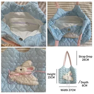 Blue heart quilted canvas bag with plush rabbit patch and pink shoulder strap detail