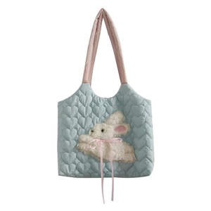 Light blue heart-quilted tote bag featuring a plush bunny patch and pink shoulder straps