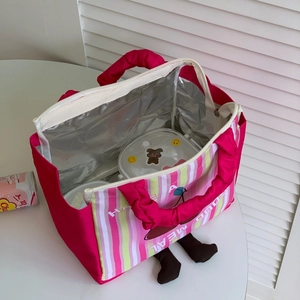 Detail of insulated interior lining and lunch box storage in pink cartoon thermal bag