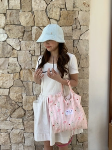 Detail of pink and white striped quilted canvas tote bag with cute bear embroidery