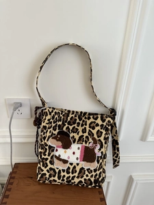 Detail of leopard print canvas bag featuring a 3D plush dachshund embroidery patch