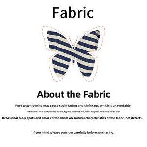 Detail of natural cotton canvas fabric with blue stripes and butterfly-shaped pattern cut