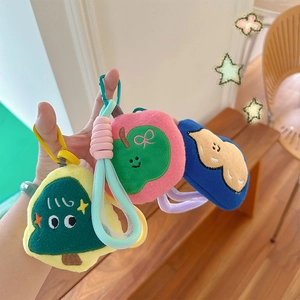 Plush keychain set featuring embroidered Christmas tree, apple, and blue doll pendants