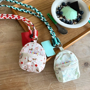 Close-up of cute floral and puppy print mini earphone pouches with heart zipper pulls