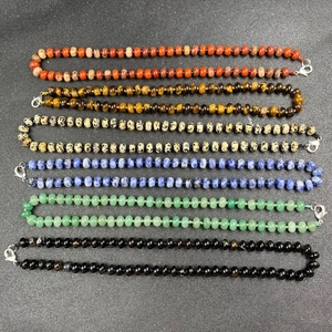 Natural stone necklace set with colorful agate and tiger eye beads on dark base