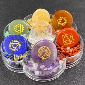 Siete piedras de curación de chakras con símbolos dorados en caja de estrella