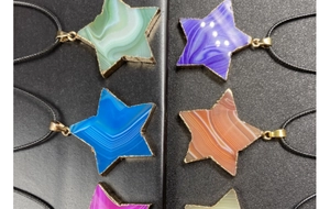 Detalle macro de colgantes de ágata en forma de estrella con bordes dorados