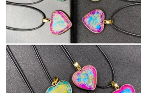 Detail view of heart-shaped emperor stone pendant with gold plating and black cord