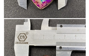 Macro shot of 40mm heart-shaped sea sediment jasper pendant with gold rim measurement