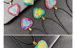 Macro shot showing heart-shaped emperor stone pendants with gold-plated edges and textures