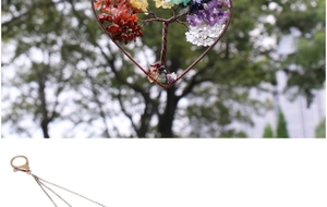 Detail of handmade wire-wrapped heart Tree of Life pendant with natural healing crystals