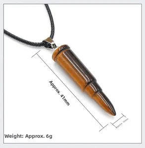 Macro view of tiger eye bullet pendant with dimensions 41mm by 10mm on woven cord
