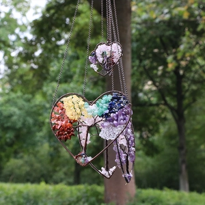 Handmade heart Tree of Life hanging ornament with natural chakra crystals in a forest
