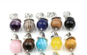 Detailed view of varied gemstone spherical pendants with silver metal witch hat caps