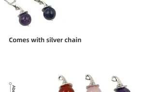 Macro detail of assorted crystal sphere pendants with witch hat metal caps and silver chains