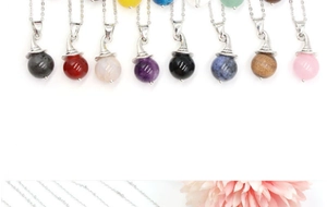 Detailed view of witch hat pendant necklaces in various natural gemstones and crystals