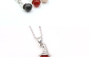 Detailed macro view of witch hat pendant necklaces with colorful gemstone beads