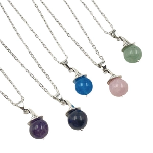 Five crystal ball witch pendants in various colors with silver chain necklaces