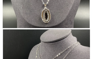 Detailed macro of a natural Brazilian agate geode pendant with silver plated edging