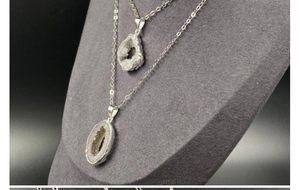 Macro detail of natural agate geode pendants with silver plating and hollow crystal core