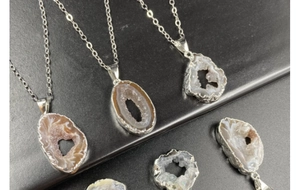 Detailed macro view of natural Brazilian agate geode pendants with silver plating